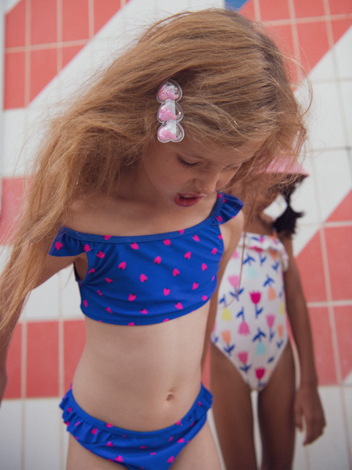 Blue 2-piece swimsuit with strawberry print for girls.