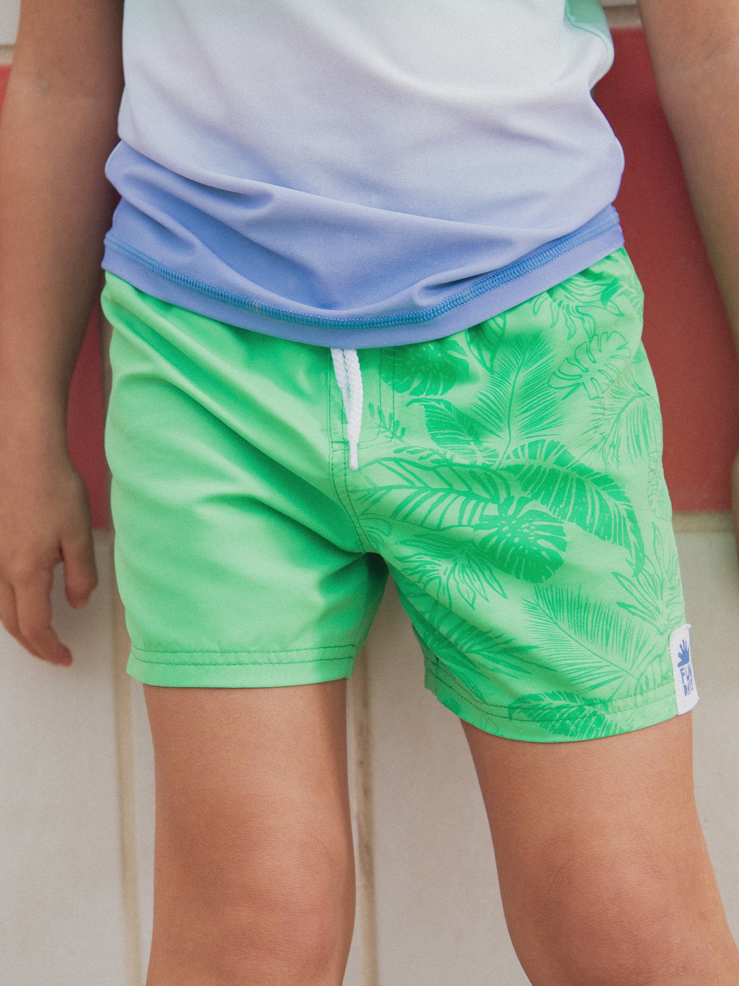 Water-reactive printed swim shorts for boys