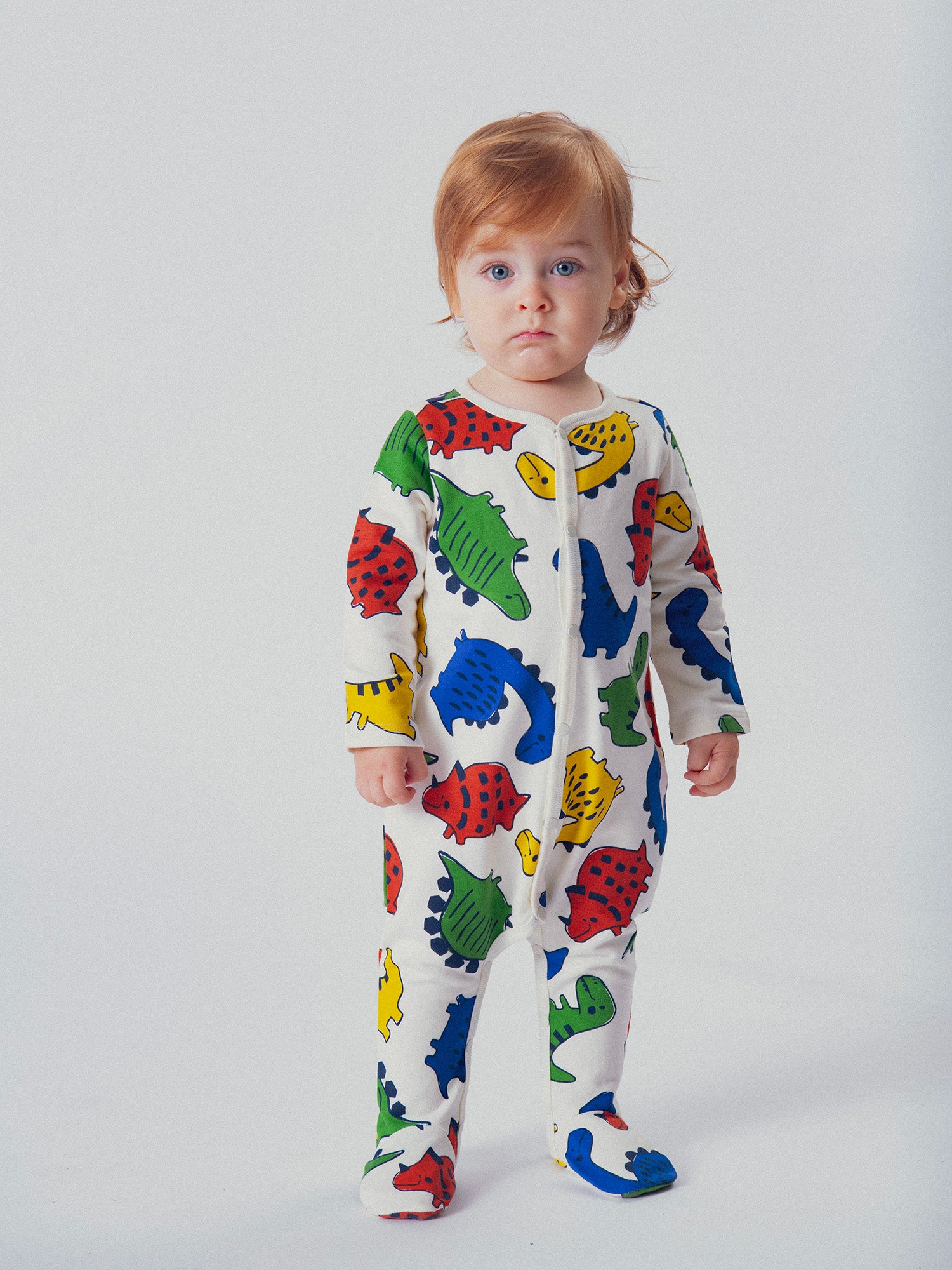 Creamy romper printed all over with dinosaurs for baby boy