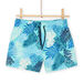 Blue swim shorts with leaf print